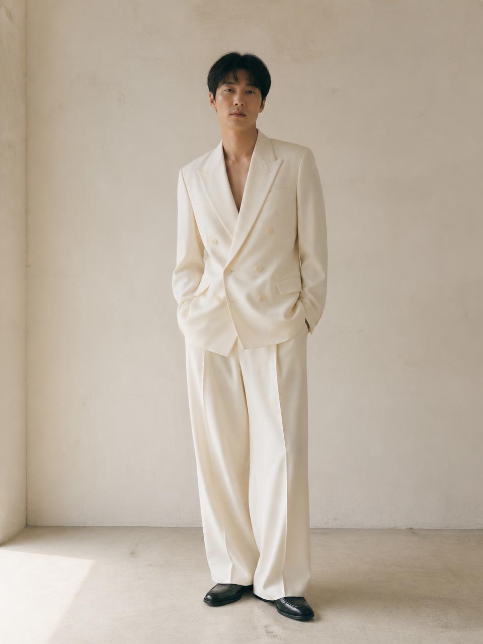 Front full-body view of the UNSTRCT 02 double breasted suit in off white